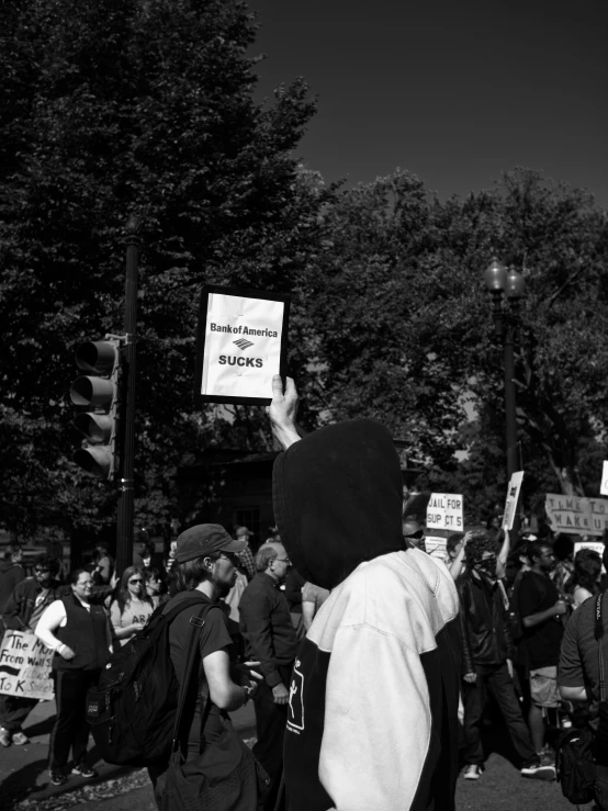a black and white picture of people protesting at a protest