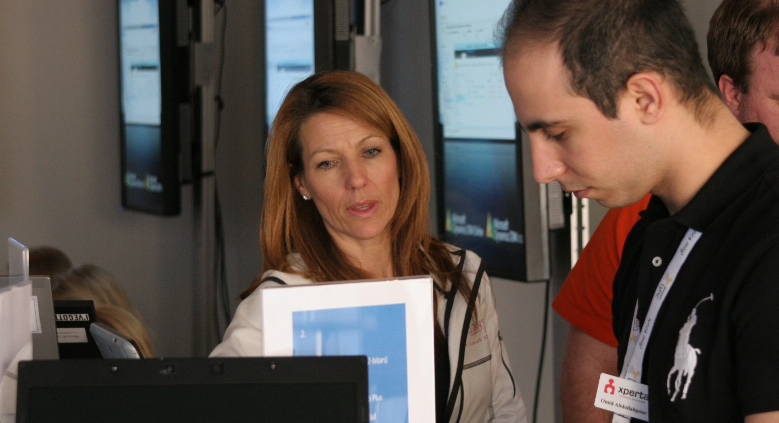 a man and a woman looking at soing in front of them