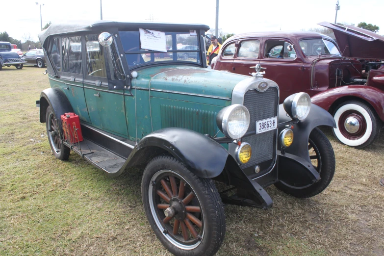 an old car with people sitting in it's seat