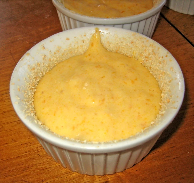 a white dish with food in it sitting on a table