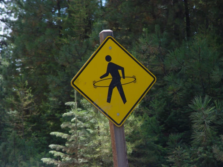 a street sign depicting a walking man using a hula hoop