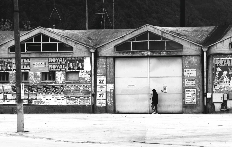 people standing in front of an old warehouse