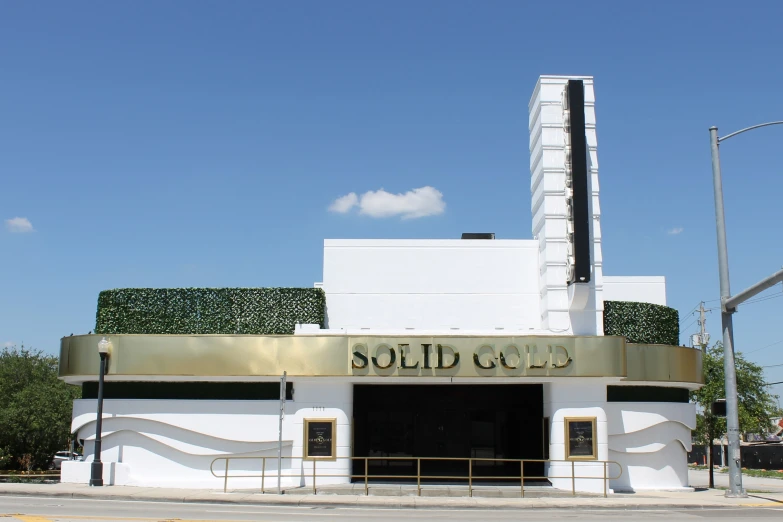 a tall white building sitting on the side of a street