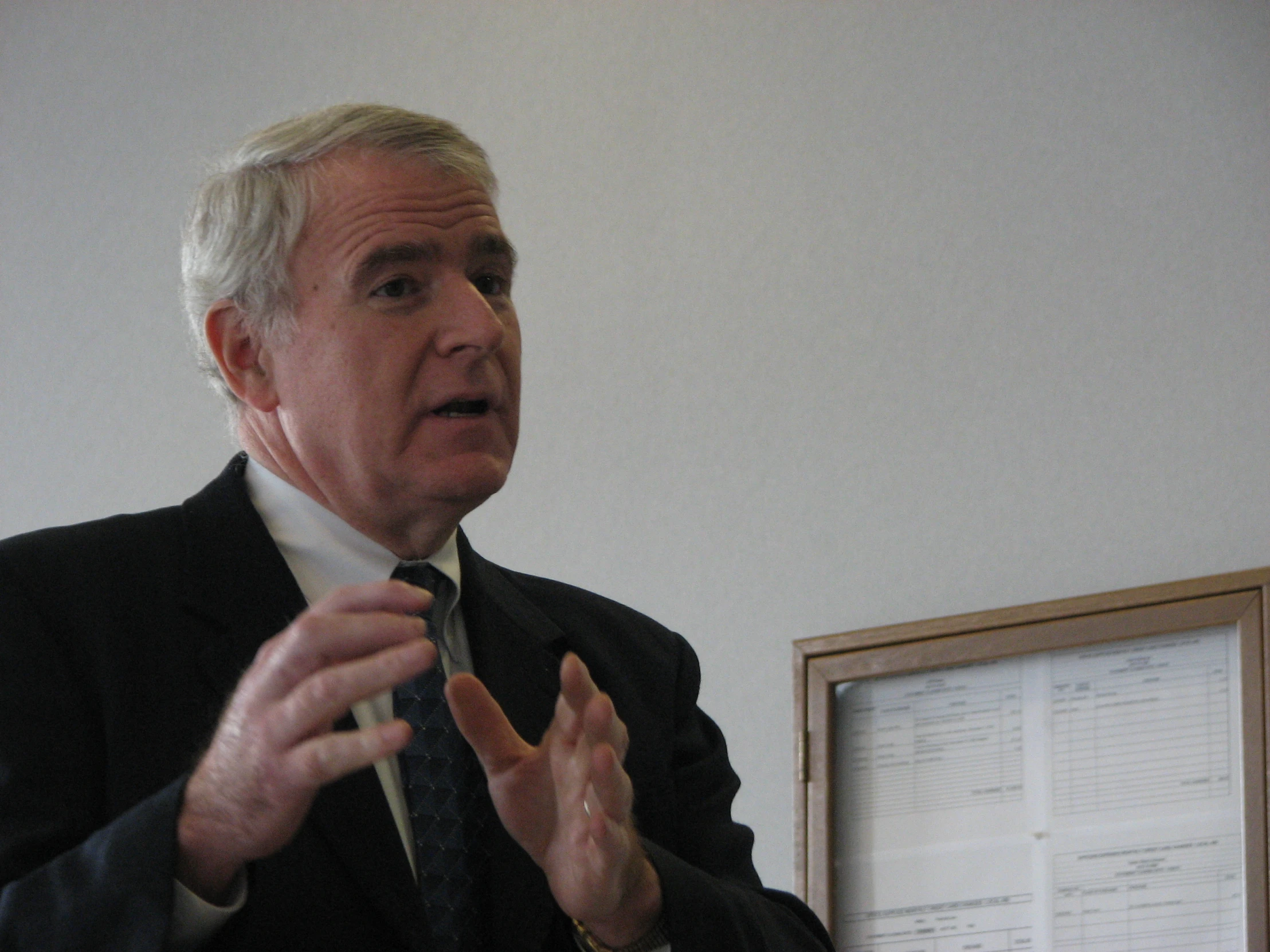 an older man wearing a suit and tie