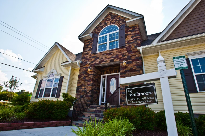 the front entrance to a residential home with landscaping