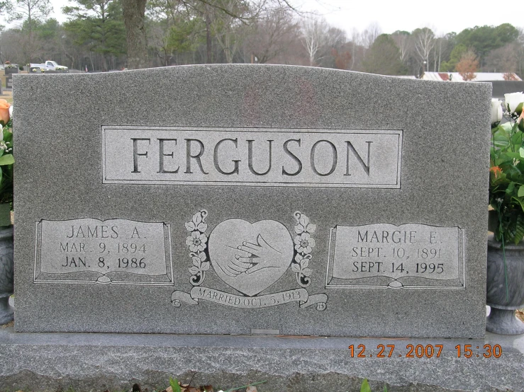 the headstone is in front of a cemetery
