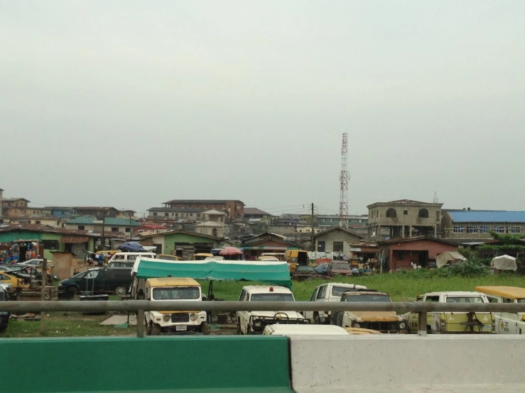 a big parking lot with some old cars and buildings in the background