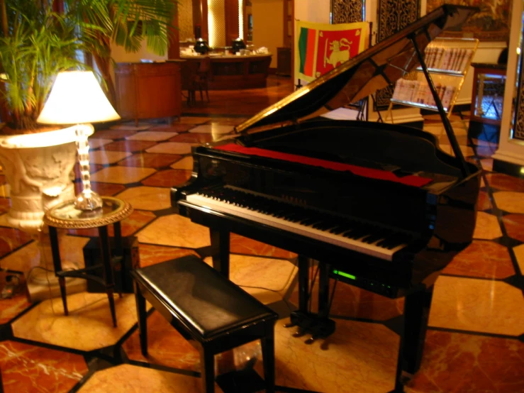 a black piano sitting on top of a marble floor