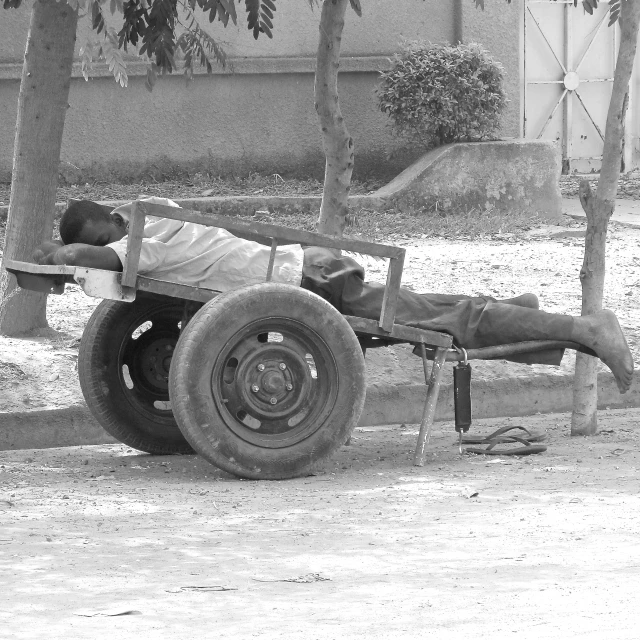 a man is asleep on top of an old truck