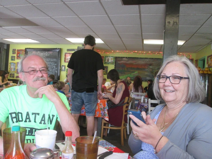 two people are sitting at the table in a restaurant