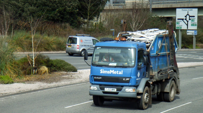 a dump truck is riding down the street