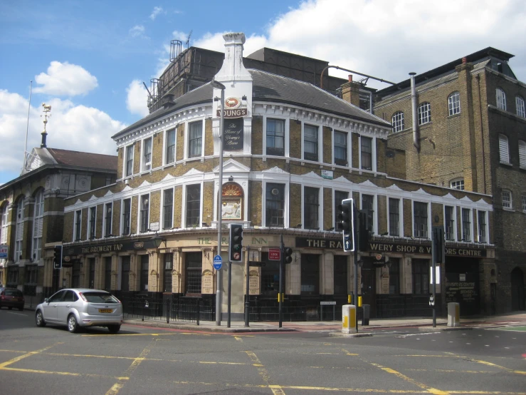 a large building on the corner with an empty street