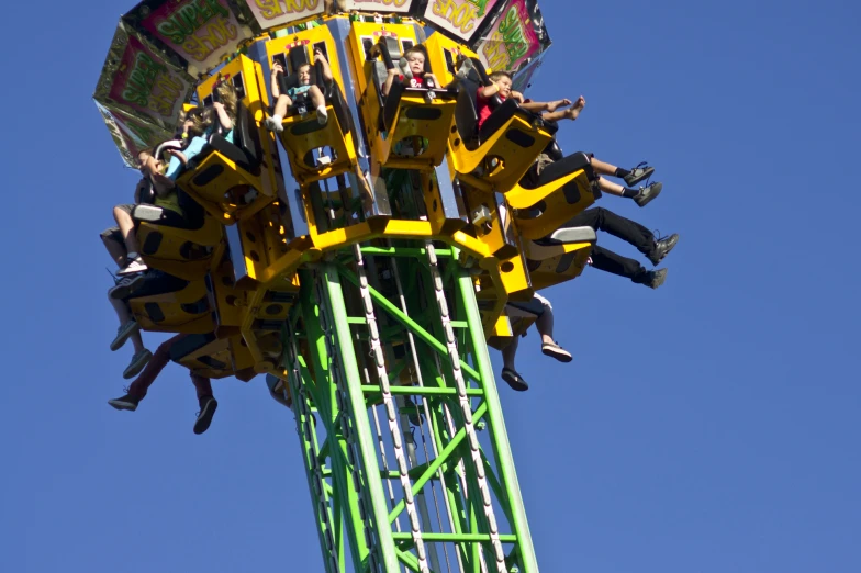 people riding a carnival ride on a sunny day