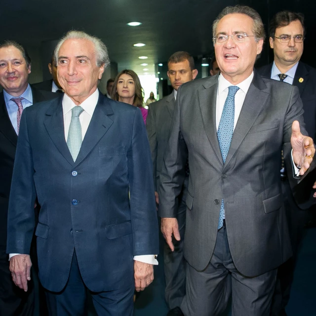 a group of men dressed in suits are walking around