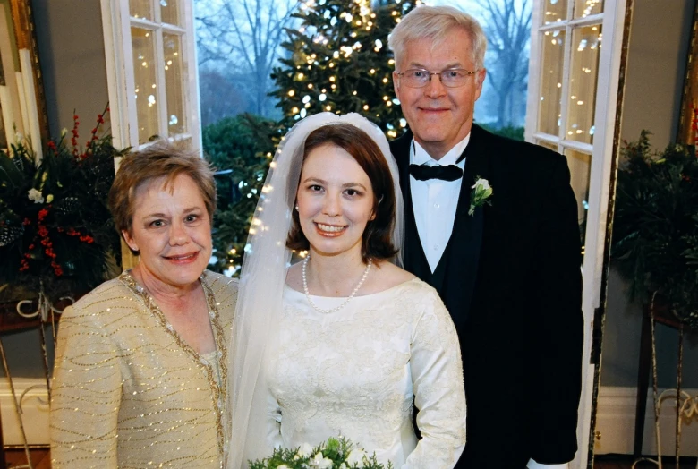 the two adults are dressed up for the wedding