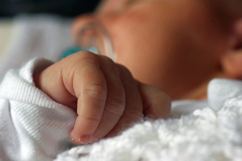 a close up view of a newborn baby sleeping