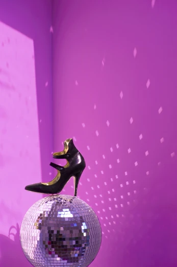 a shoe is suspended on top of a mirror ball