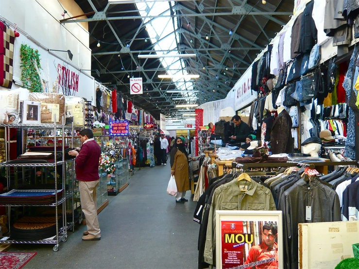 an image of shoppers in a store with lots of clothing