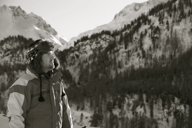 a black and white po of a man at the top of a mountain