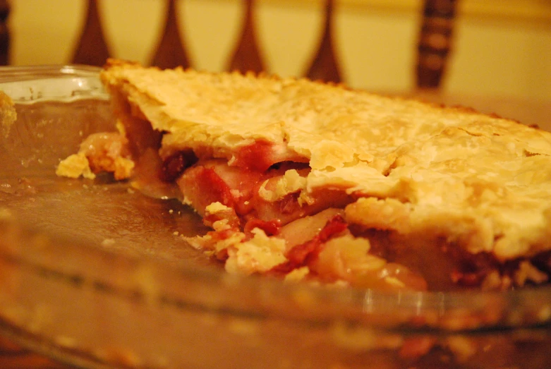 a partially eaten pie sits in a dish