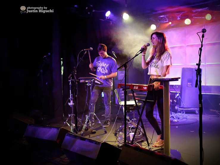 a group of people with musical instruments singing on stage