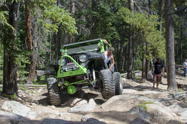 some people on a trail by a jeep