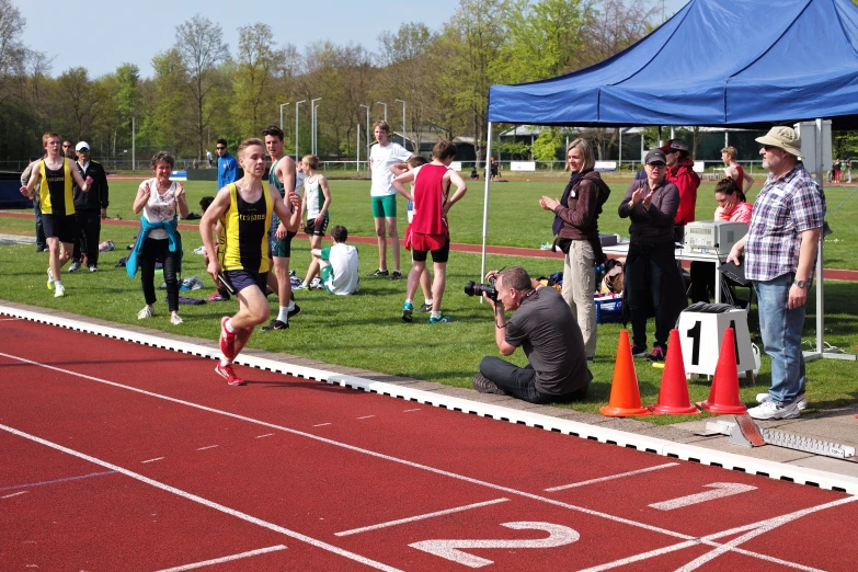 a man is kneeling down on the side of a track