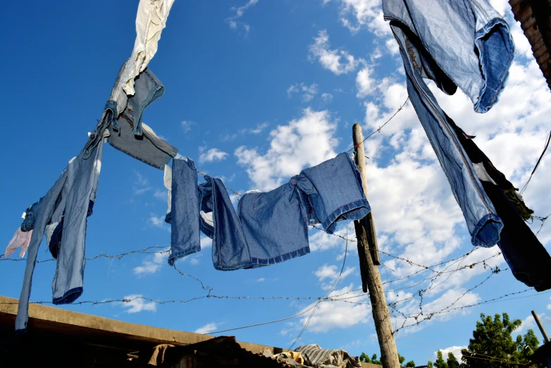 several blue towels are hanging on a rope