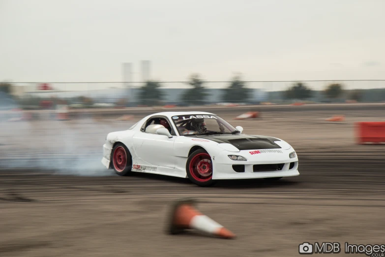a drifting car with smoke billowing out its tires