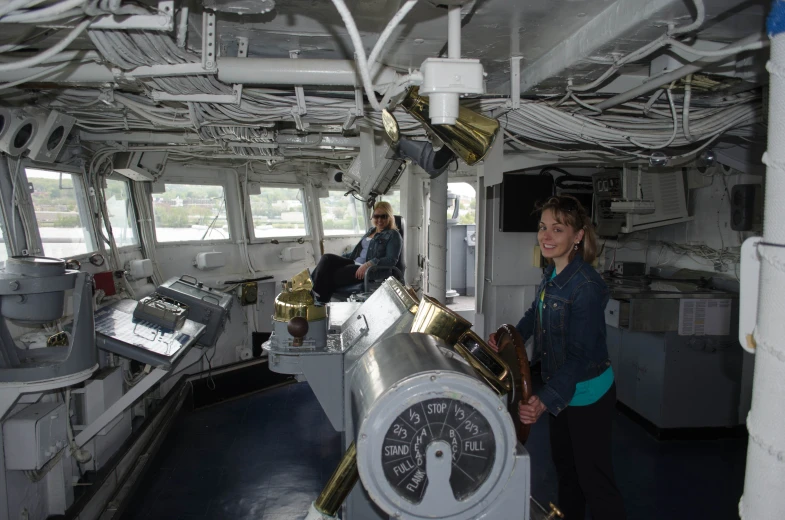 woman standing in a ship with a gauge on the deck