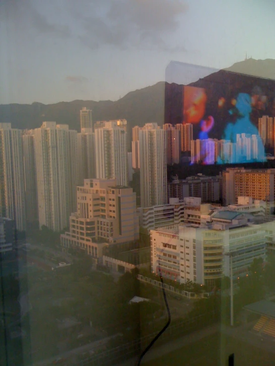 the view from a train window with city in the background