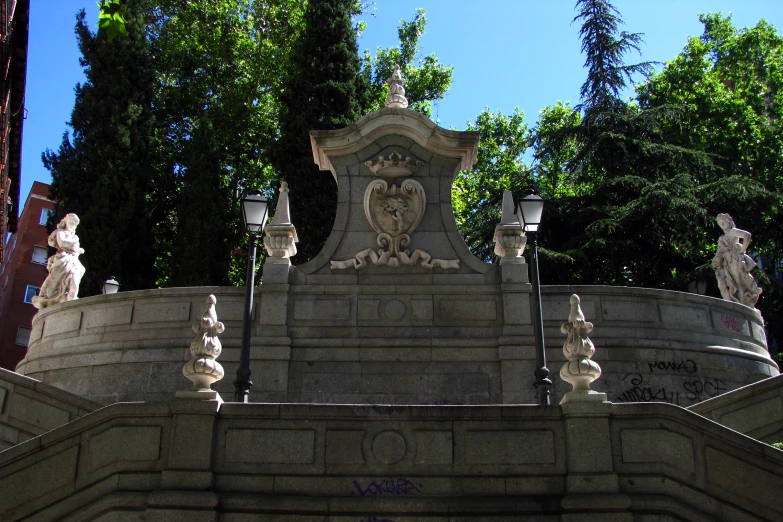 statues are located on a concrete pedestal in a park