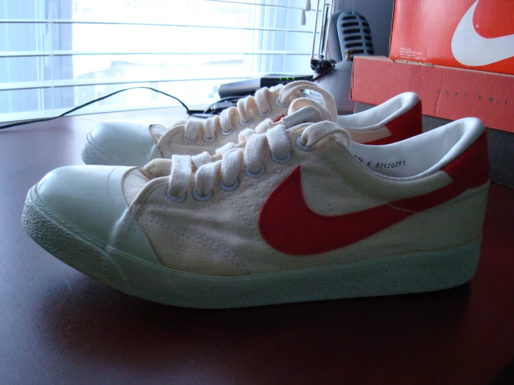 a white and red nike sneaker on a desk