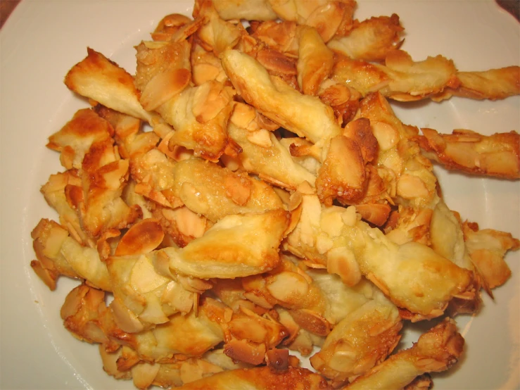 a pile of crispy pieces on a white plate