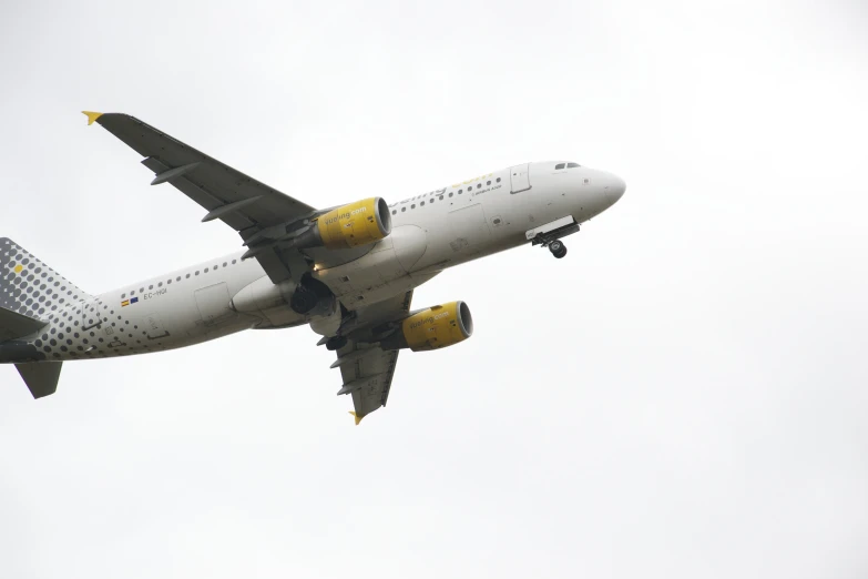 a airplane with yellow paint is seen in flight