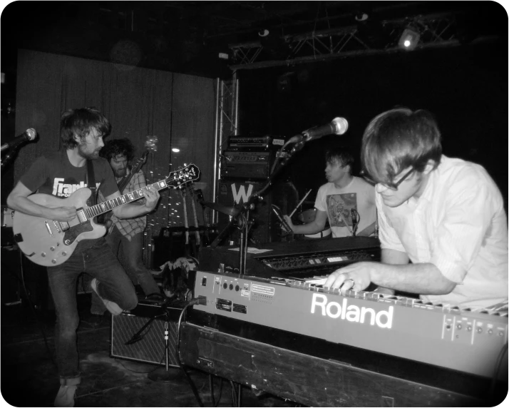 a black and white po of two men playing keyboards