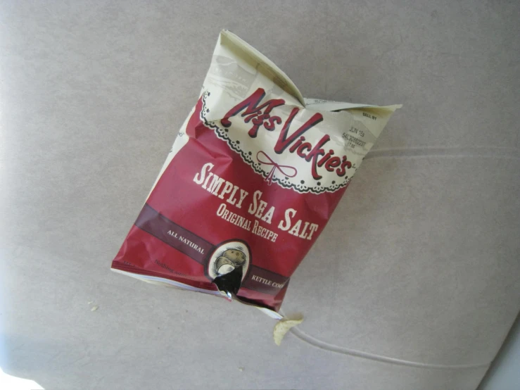 a bag of sea salt next to a rope on a table