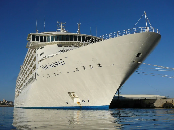 a large boat floats in the ocean near another boat