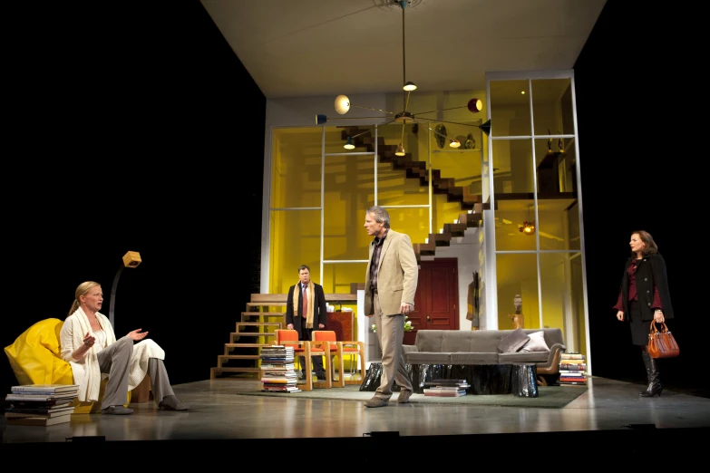 people sit on stage in front of a stairwell