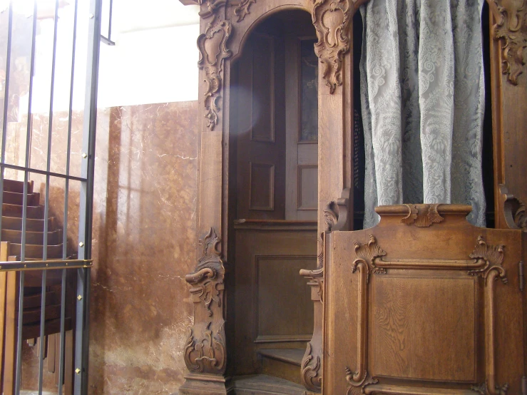 there is an old carved wooden room with a window in it