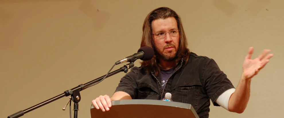 a man giving a speech with his hand out