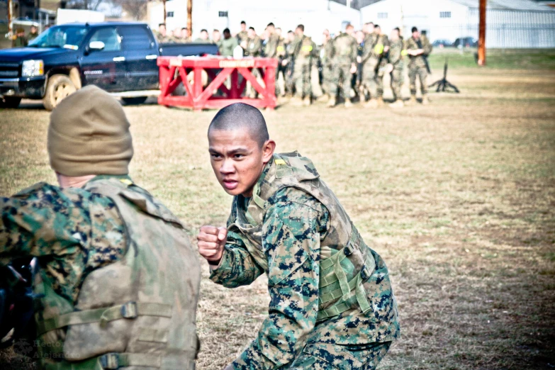 a military woman standing in front of another woman