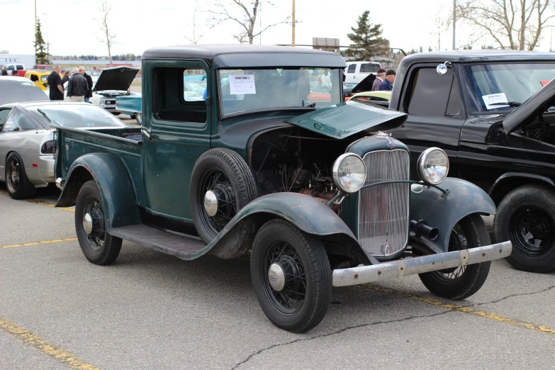 old cars are parked near other classic vehicles