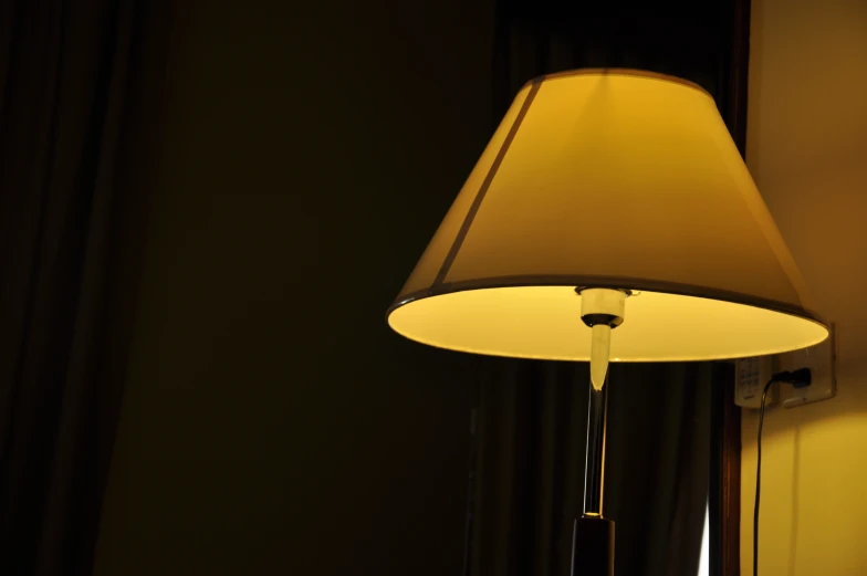 an elegant floor lamp in a dimly lit room