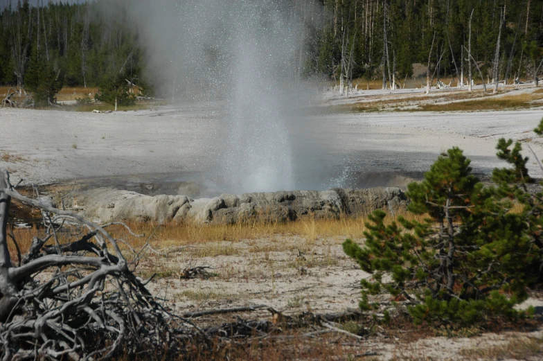 a large geyser spewing water from the ground