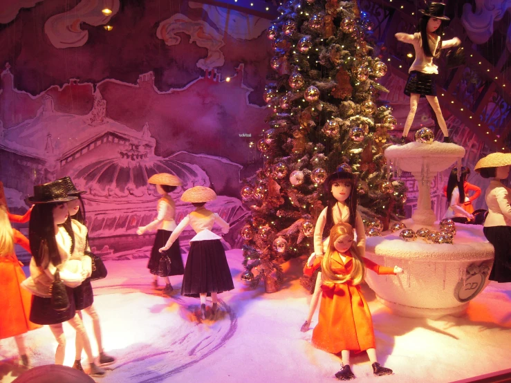 holiday window display with christmas trees and dolls