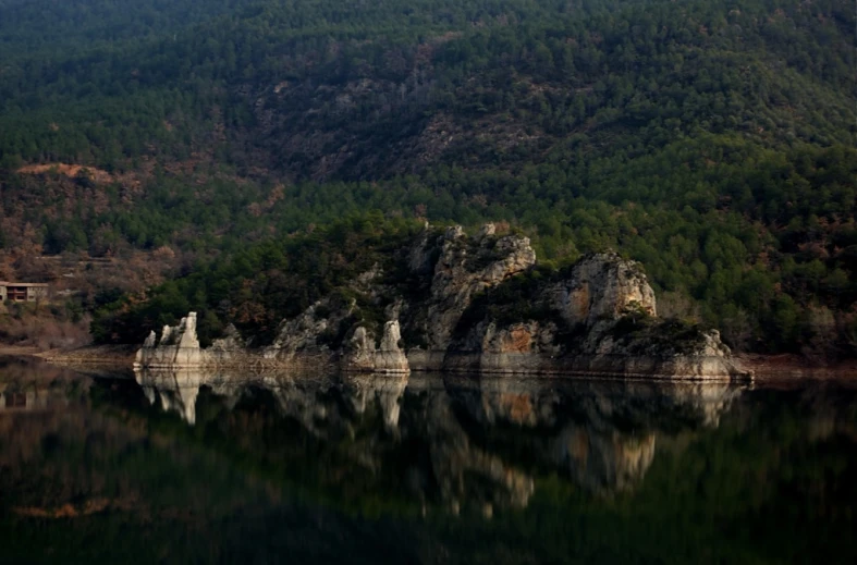 a mountain sitting beside a large body of water