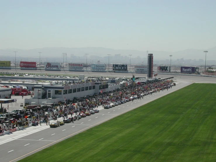 the view of a crowd gathered near an airport on a sunny day