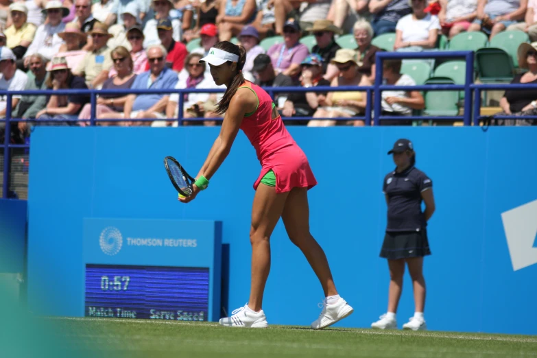 a woman holding her tennis racquet ready to serve