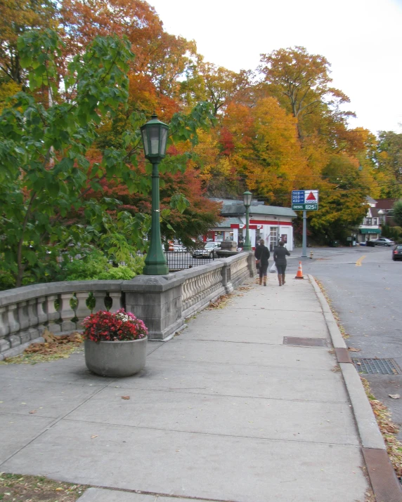 a street lamp that is on top of a sidewalk